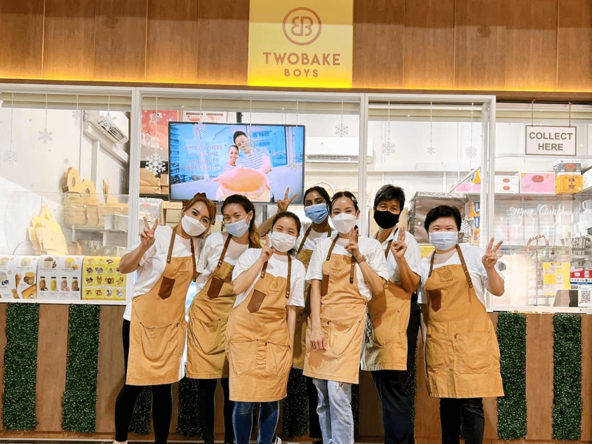 Staff of Two Bake Boys posing in front of its takeaway kiosk.