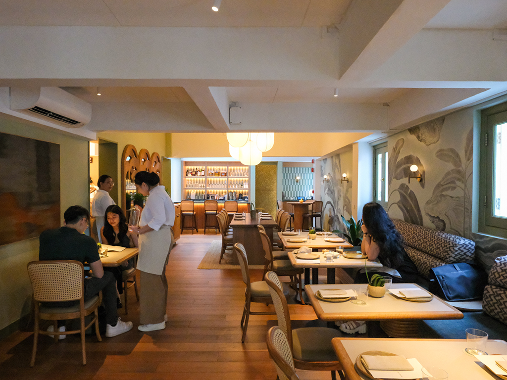 The restaurant is decked out in colonial-style influences, from the rattan furniture and lamps to botanical wallpaper. Photo: Gary Lim/HungryGoWhere Belimbing