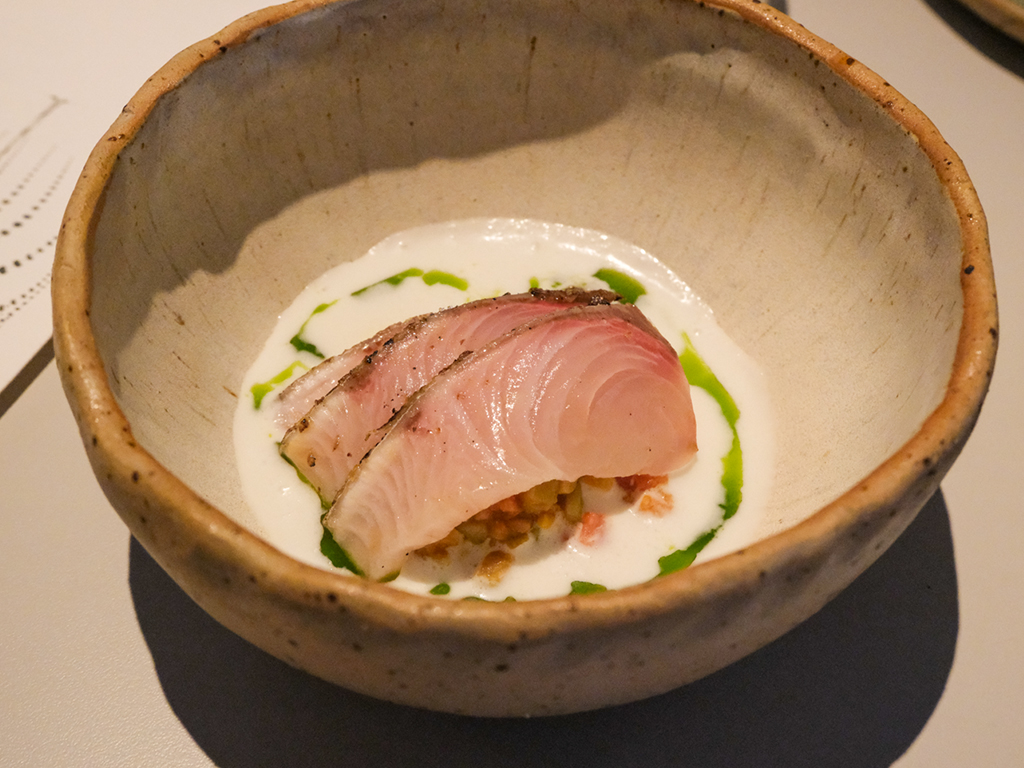 Slices of kampachi sit in a chilled coconut curry alongside pink guava and mussels. Photo: Gary Lim/HungryGoWhere Belimbing