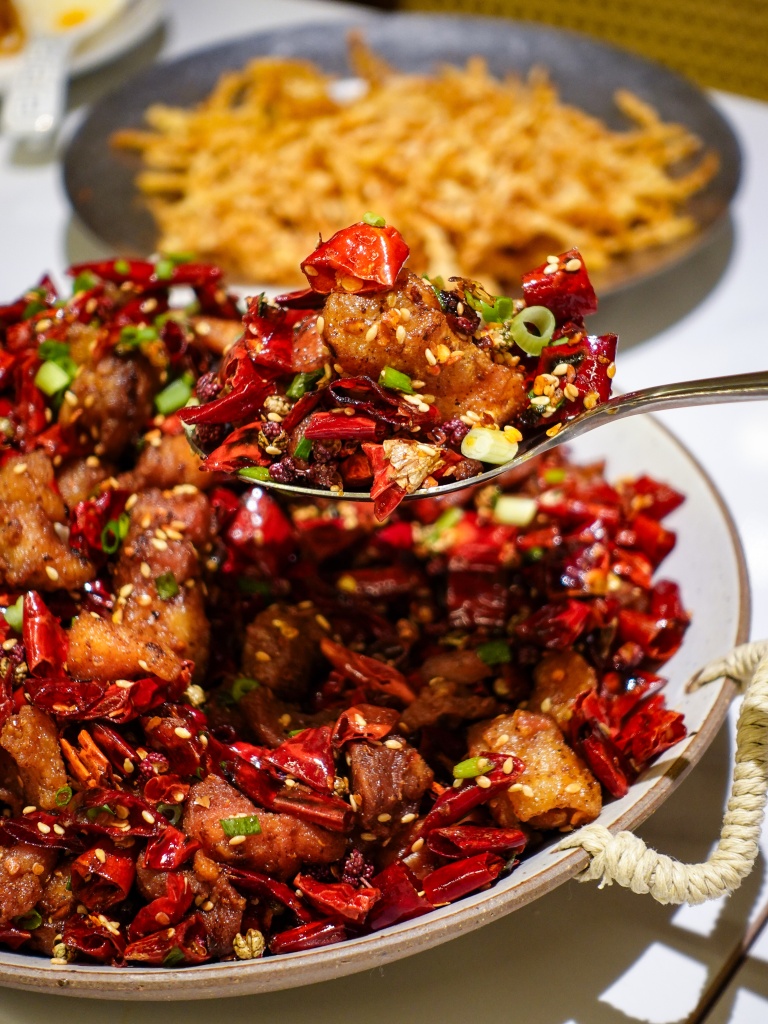 Spicy chilli chicken with cheesy rice cake. Photo: Sarah Chua/HungryGoWhere Chengdu Bowl Changi T3