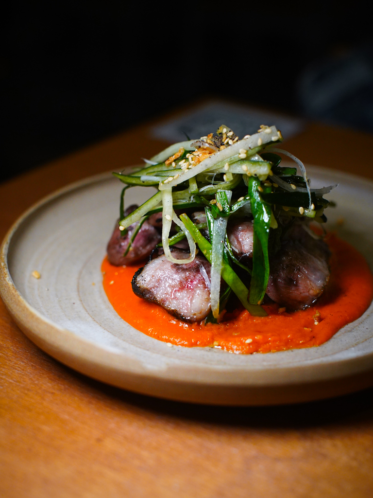 Fatty pork collar with tangy romesco. Photo: Evan Mua/HungryGoWhere almost famous