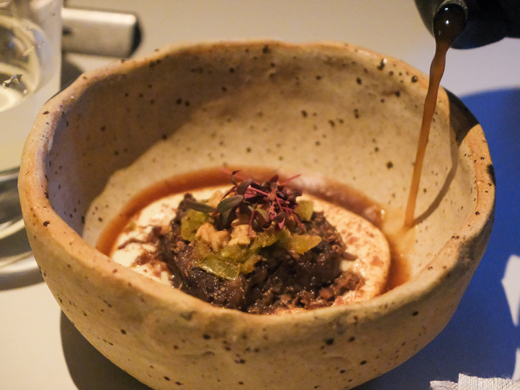 Braised oxtail with green tomato and smoked potato in beef broth. Photo: Gary Lim/HungryGoWhere Belimbing