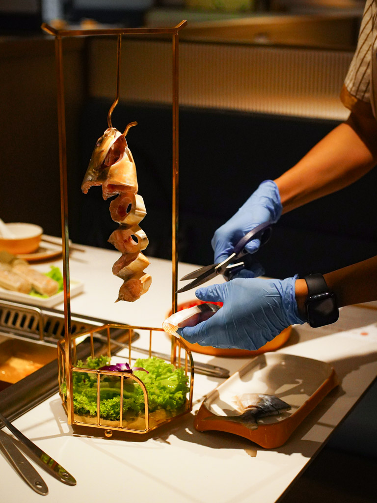 A whole pomfret hanging from a hook! Photo: Evan Mua/HungryGoWhere shuai jiang jun hotpot
