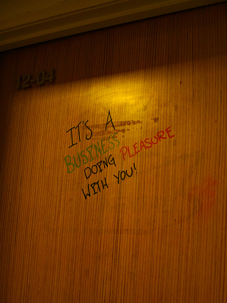 The scribblings on their nondescript door tells you all you need to know. Photo: Evan Mua/HungryGoWhere the cocktail office singapore