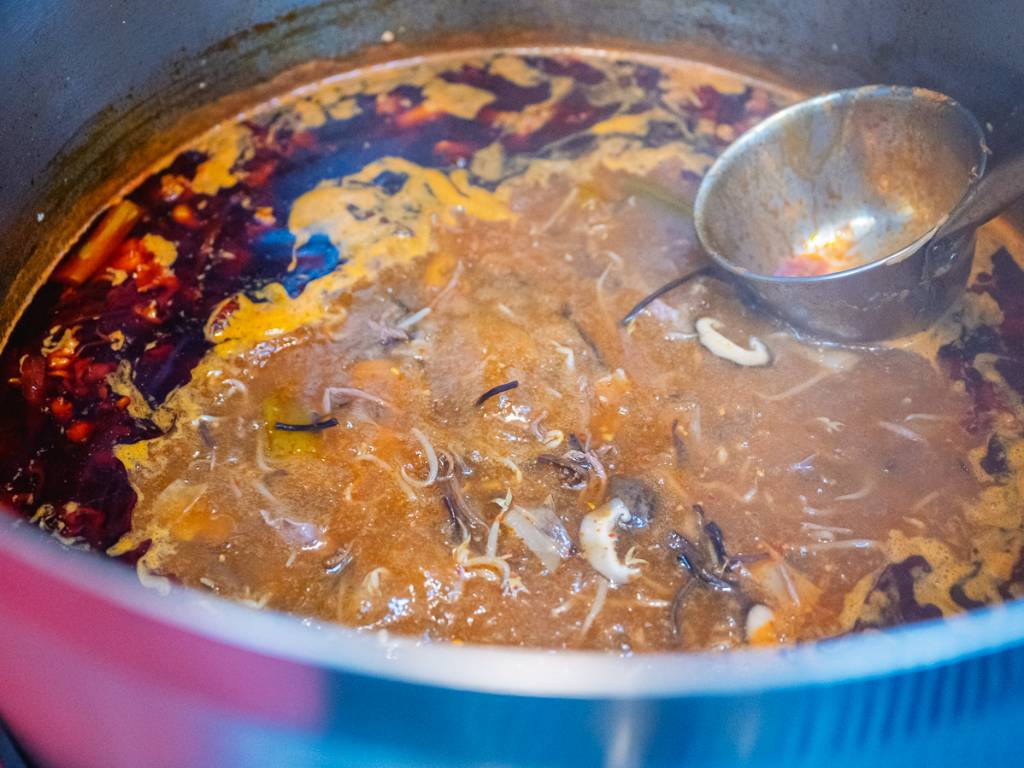 Skimming the impurities off the surface. Photo: Abdul Rahim Anwar/HungryGoWhere kalguksu seoul noodle shop