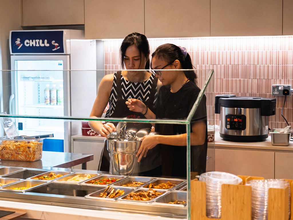 Desiree working with a staff member. Photo: Abdul Rahim Anwar/HungryGoWhere peko peko