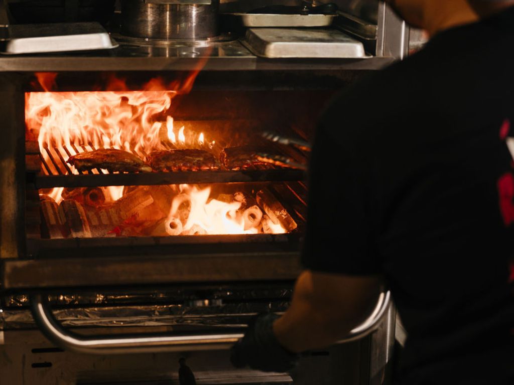 Fi’s kitchen is where the essence of wood-fire cooking comes to life. Photo: Fi Woodfire Thai Fi Woodfire Thai