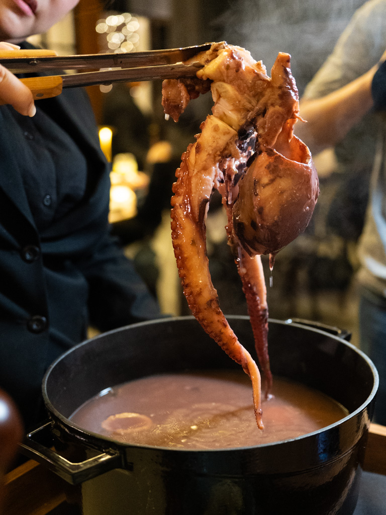The full octopus is presented steaming in its pot — a head-turning moment. Photo: Angeline Ang/HungryGoWhere il giardino botanic gardens