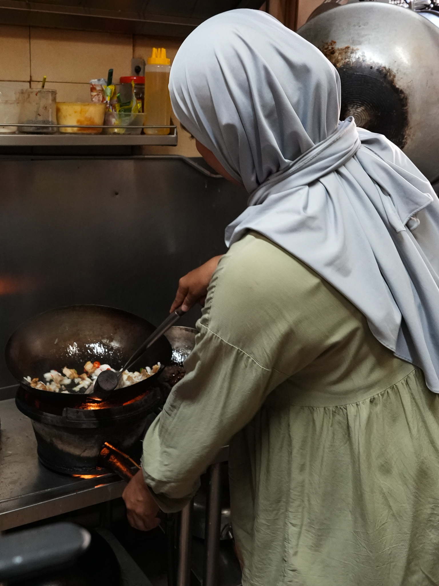 Hidayah shows us the small, humble kitchen at the back. Photo: Angeline Ang/HungryGoWhere nanay's kitchen