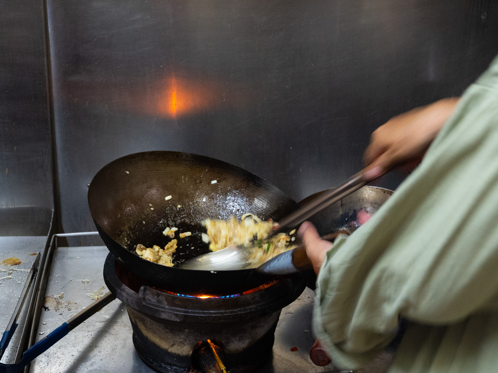 Chicken sisig in the making — sizzling hot off the wok. Photo: Angeline Ang/HungryGoWhere nanay's kitchen