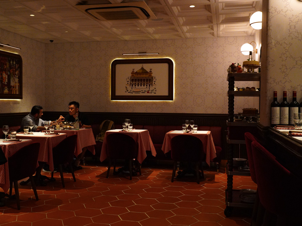 Rustic wallpaper and checkered tablecloth add to the immersion. Photo: Evan Mua/HungryGoWhere la vache singapore
