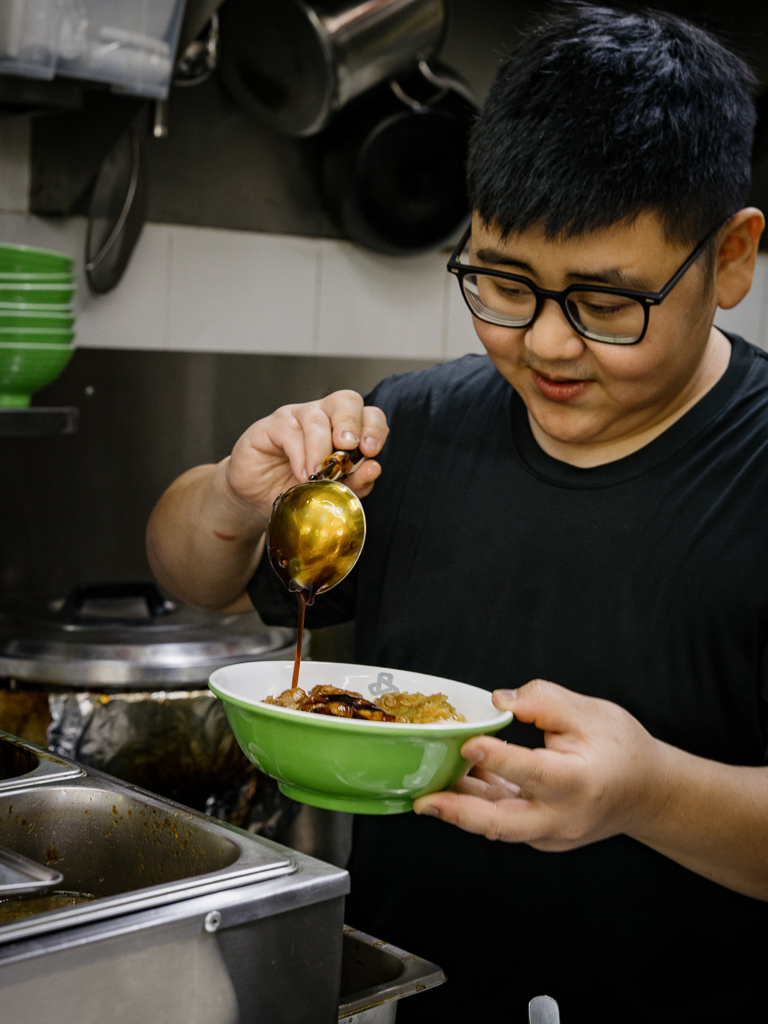 Wei Jie pouring his secret braise sauce over a rice bowl. Photo: Ravin Thiruchelvam/HungryGoWhere Braissers Rice Bowl Tanjong Pagar