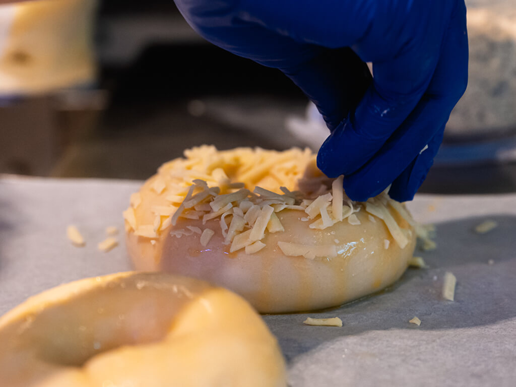 After the bagels are boiled for close to 30 minutes, the dough is then seasoned with different toppings, such as sesame seeds or cheddar, before it is placed in the oven. Photo: Abdul Rahim Anwar/HungryGoWhere The Bagel Bunch
