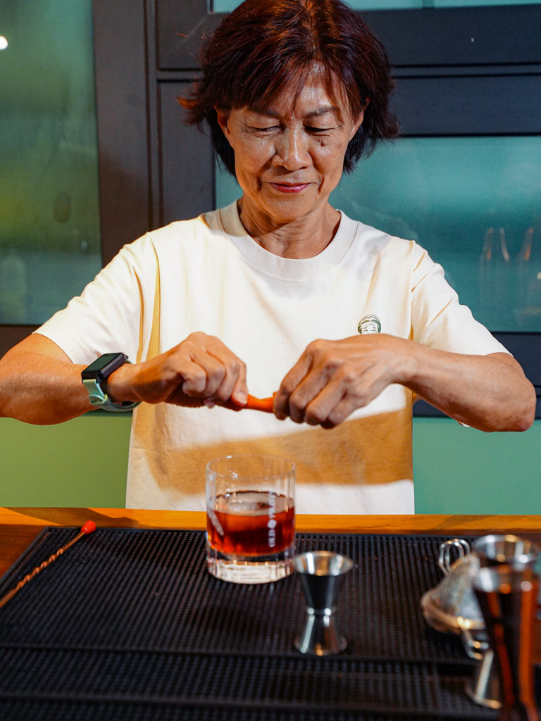 Here she is making a solid negroni for us. Photo: Evan Mua/HungryGoWhere mamashop inc singapore