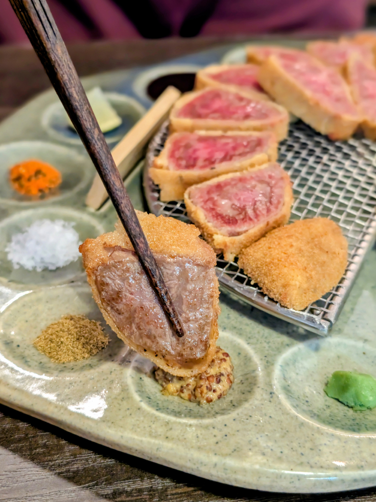 A piece of A5 ribeye katsu dipped in Dijon mustard. Photo: Zawani Abdul Ghani/HungryGoWhere Gyusei Gyukatsu Wagyu-Steakhouse