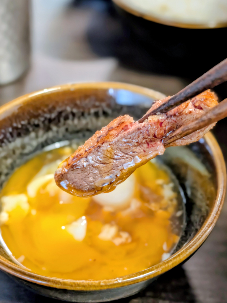 A piece of Australian tenderloin katsu dipped in runny egg yolk. Photo: Zawani Abdul Ghani/HungryGoWhere Gyusei Gyukatsu Wagyu-Steakhouse