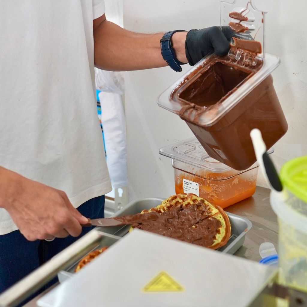 Owner Awad spreads a super thick layer of choco filling onto the waffle. Photo: Shannon Yap/HungryGoWhere wad coffee