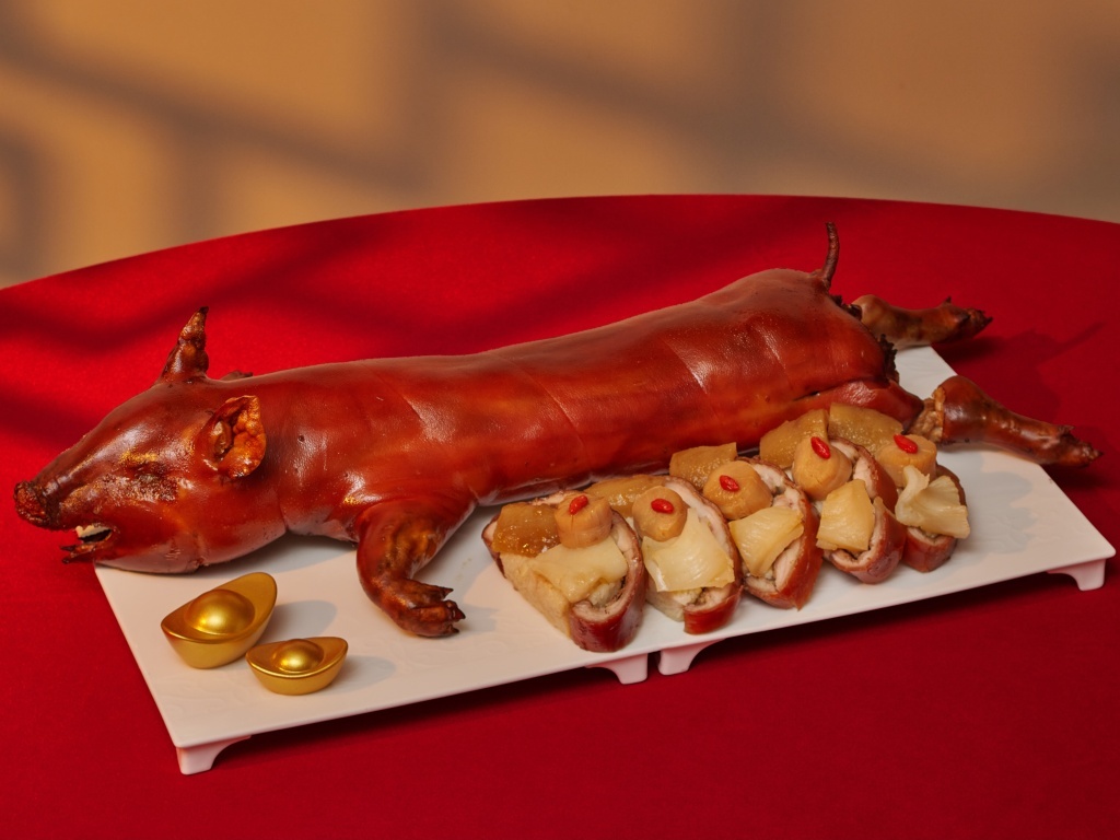 Golden Peony’s roasted suckling pig, stuffed with fish maw, sea cucumber, and conpoy orzo rice. Photo: Conrad Singapore Marina Bay cny dinners 2026