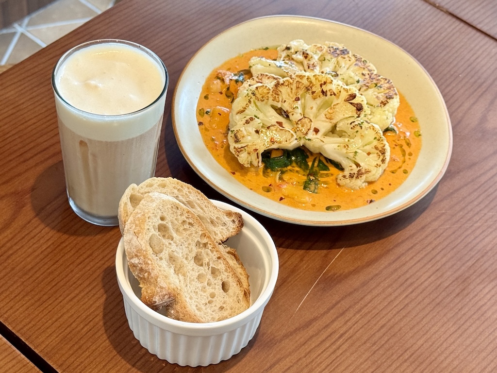 The roasted cauliflower slab, with sourdough toast to soak up all the sauce. Photo: Hannah Tan/HungryGoWhere merle & co
