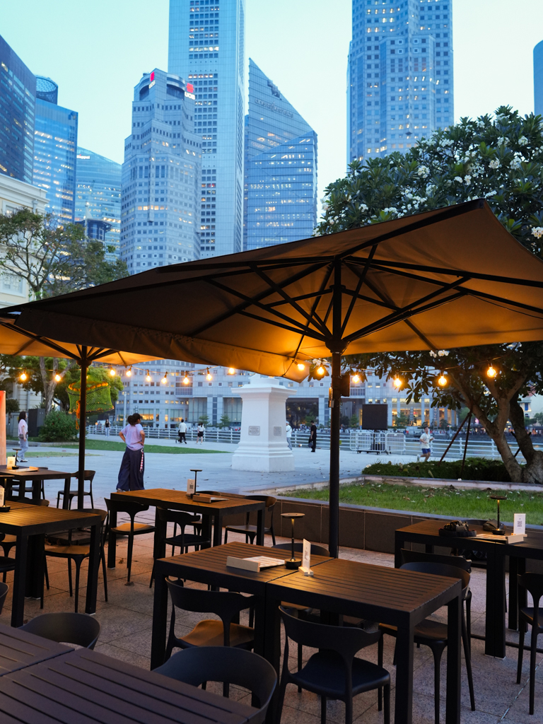 The outdoor seating is a calm spot that gets prettier as the sky darkens, with string lights overhead and the tall buildings in the background. Photo: Angeline Ang/HungryGoWhere Jeju Haenyeo