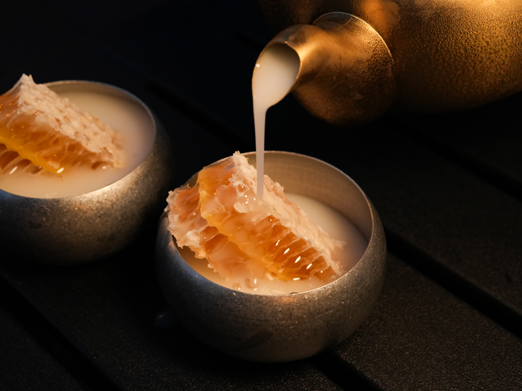 Pour the makgeolli into the bowls and over the honeycomb that’ll melt. Photo: Roma Chonkar/HungryGoWhere Jeju Haenyeo